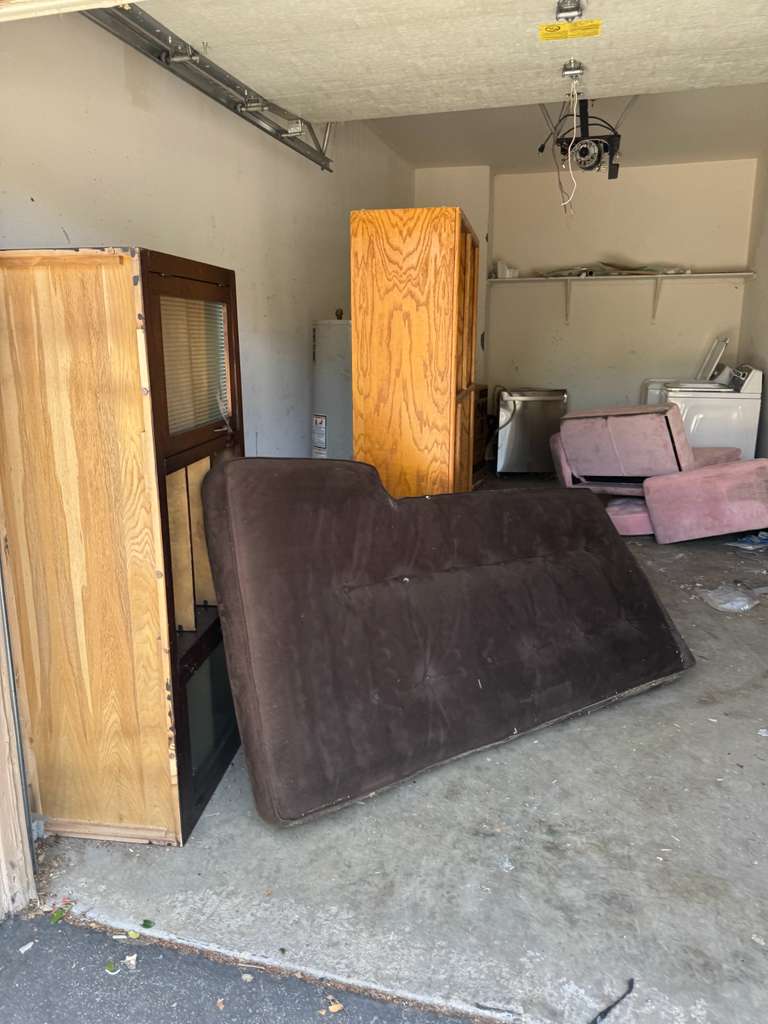 Residential garage cleanout with futon, cabinets and appliances — junk removal Los Angeles
